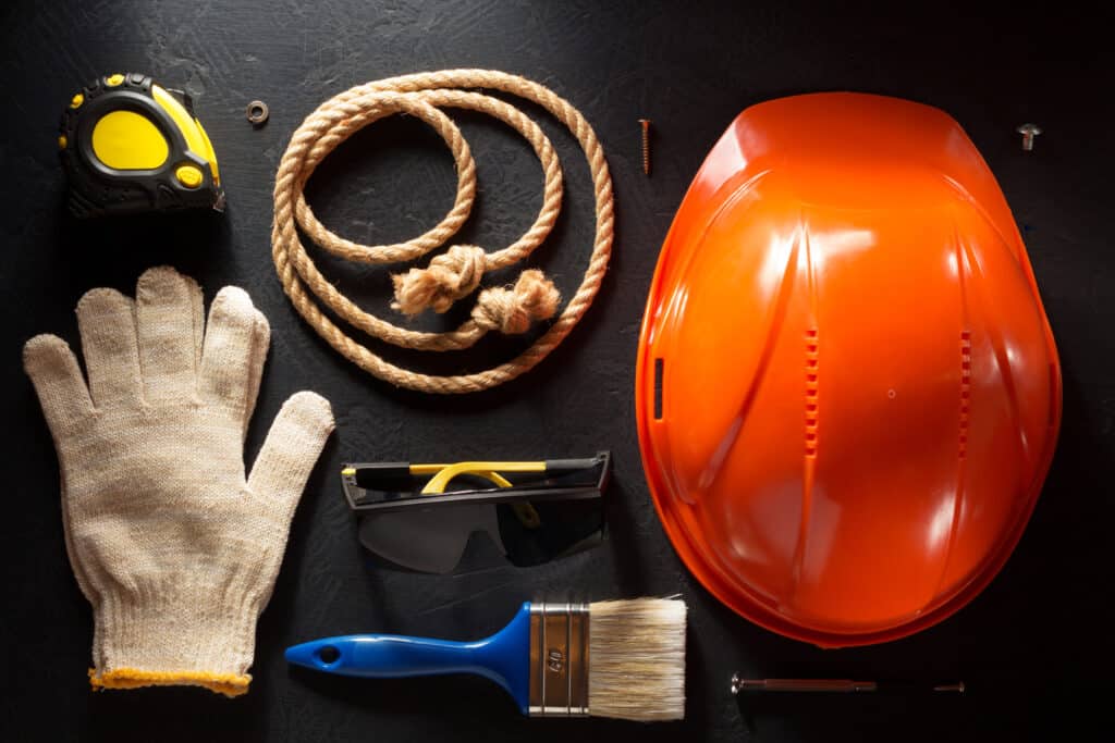 hardhat and tools on black background