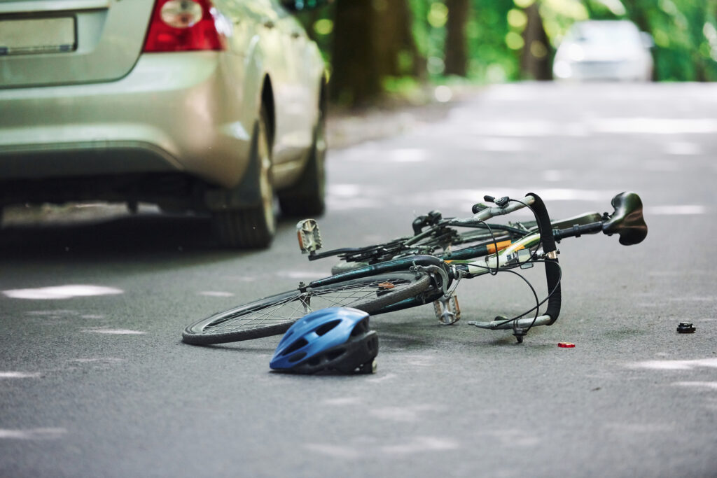 A Bicycle accident involving a silver colored car accident