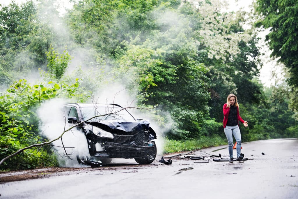 A frestrated woman making a call after a car accident