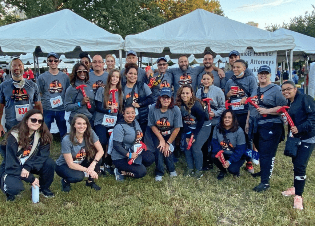 Illinois Hammer attorneys with custom shirts and toy hammers at Race Judicata in Lincoln Park, a benefit run for the Chicago Volunteer Legal Services posing for a picture