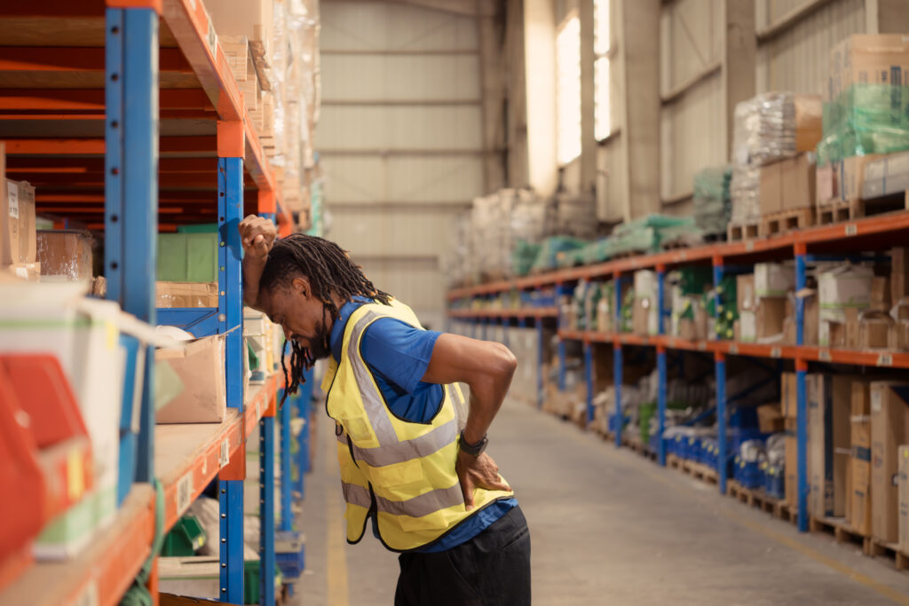 Warehouse worker and back pain after moving heavy items